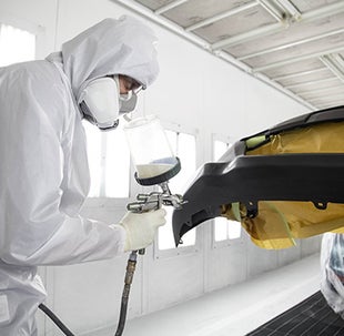Collision Center Technician Painting a Vehicle | Wilson Toyota of Ames in Ames IA
