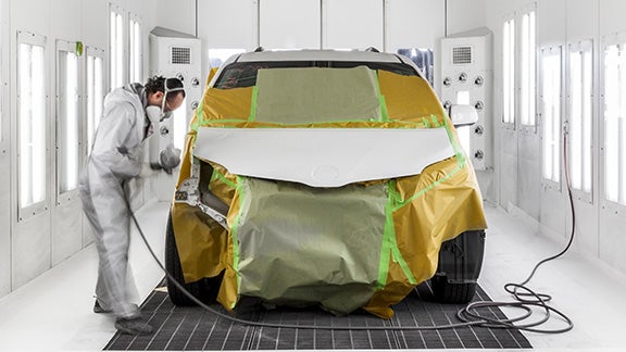 Collision Center Technician Painting a Vehicle | Wilson Toyota of Ames in Ames IA